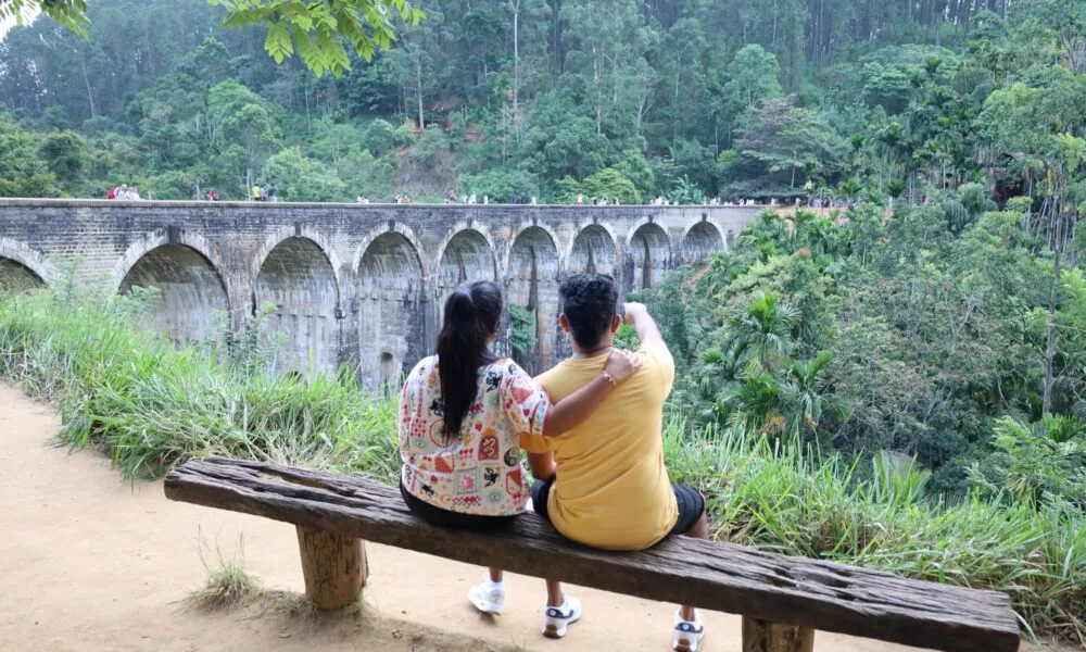 Travellers enjoying the view of Sri Lanka's iconic Nine Arches Bridge in Ella