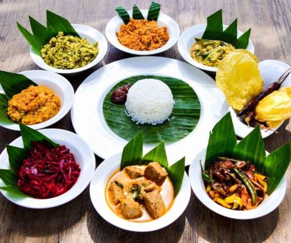 Traditional Sri Lankan rice and curry platter featuring vegetables curries sambol and papadum